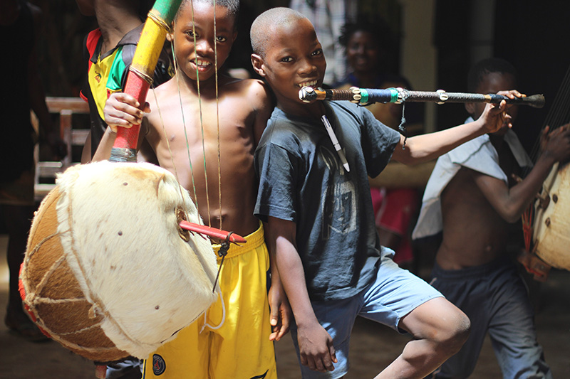 children posing with traditional guinean instruments